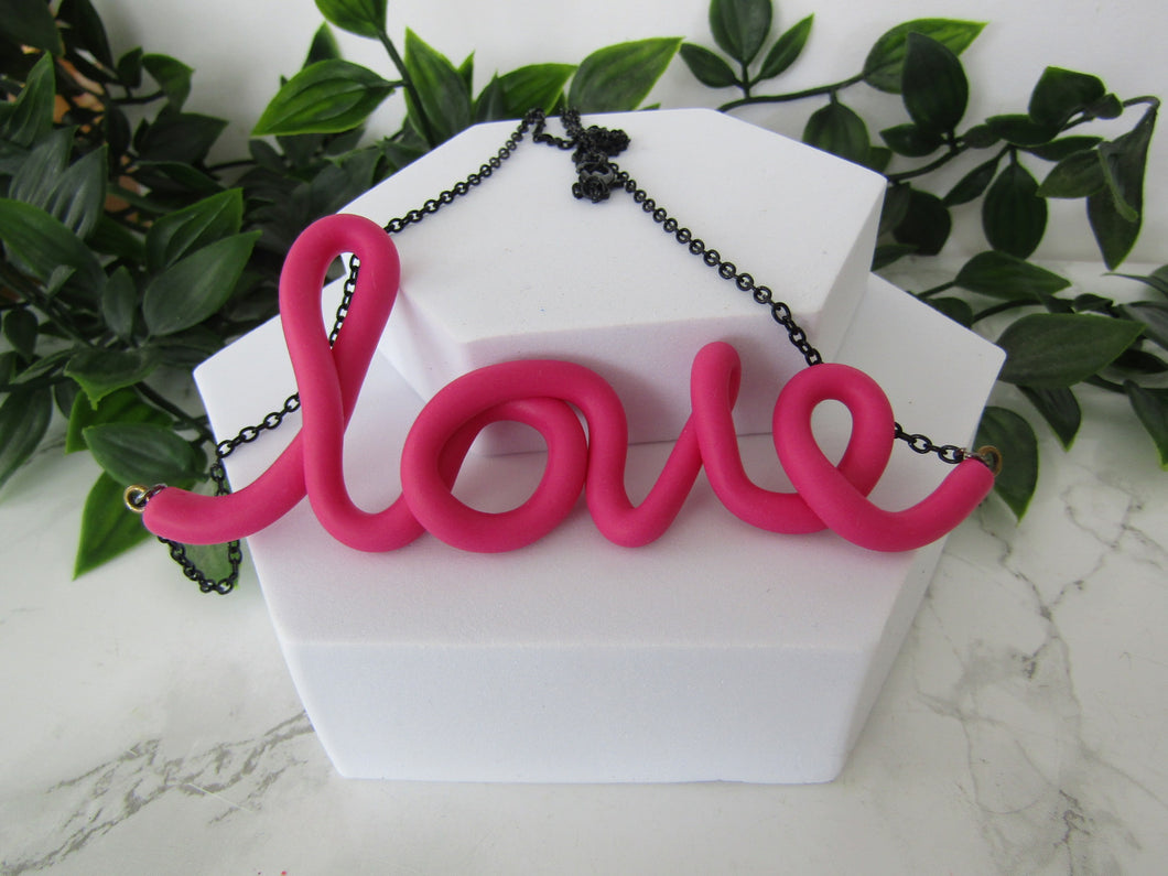 Induere | Handmade LOVE Necklace | Cursive Polymer Clay Word Pendant | Raspberry Pink