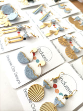 Polymer clay dangle earrings with circle gold coloured circles. Handmade earrings, Local gift shop small business Leeds. Made in the UK