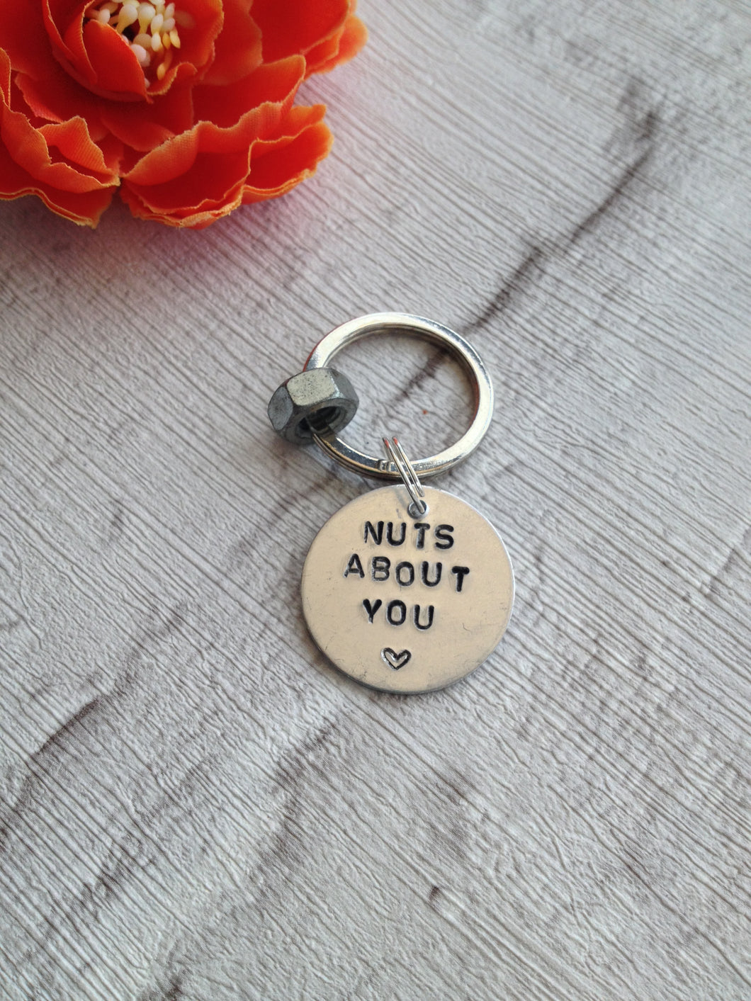 Nuts about you hand stamped metal keyring with
